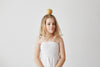 Girl with an apple balanced on her head