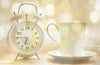 white clock, tea cup, and saucer 