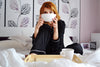 Woman drinking tea in bed