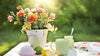 Flowers in a vase on a table with slimming sun tea and snacks