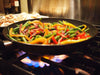 Stir fry with tea cooking on a stove
