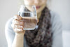 Woman holding up a glass of water